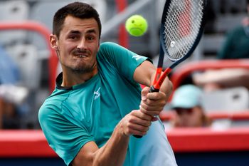 Aug 4, 2019; Montreal, Quebec, Canada; Bernard Tomic of Australia plays a shot against Marc Polmans of Australia (not pictured) during the Rogers Cup tennis tournament at Stade IGA. Mandatory Credit: Eric Bolte-Imagn Images