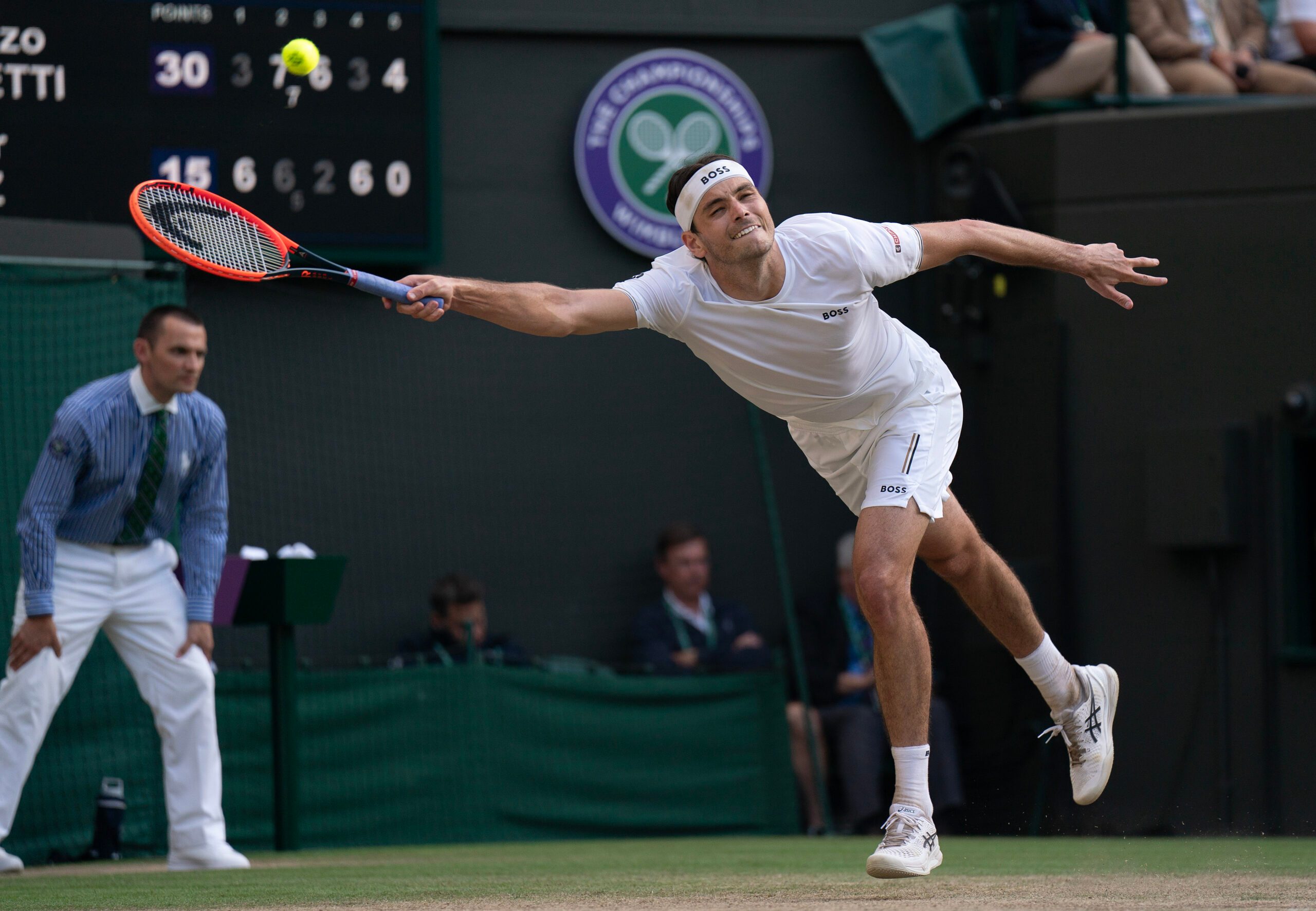 Jul 10, 2024; London, United Kingdom; Taylor Fritz of the United States returns a shot during his match against Lorenzo Musetti of Italy (not shown) on day 10 at All England Lawn Tennis and Croquet Club. Mandatory Credit: Susan Mullane-Imagn Images