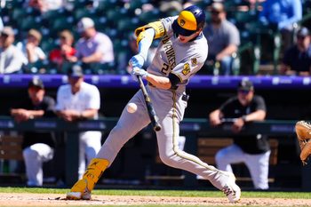 Apr 10, 2025; Denver, Colorado, USA; Milwaukee Brewers outfielder Christian Yelich (22) doubles in the fourth inning against the Colorado Rockies at Coors Field. Mandatory Credit: Ron Chenoy-Imagn Images