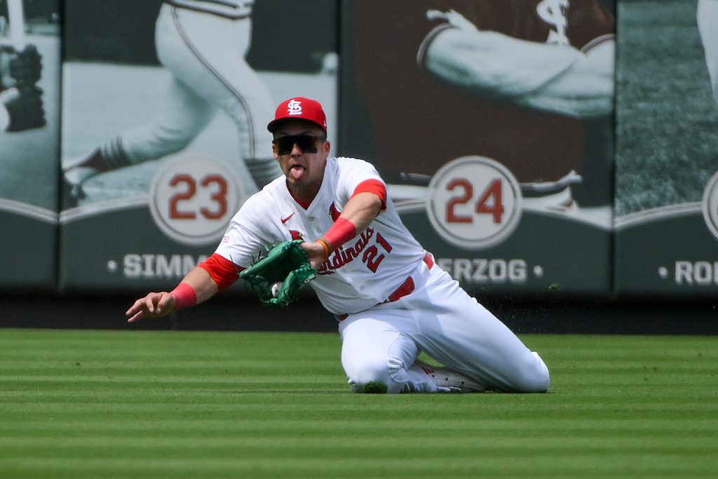 Jun 11, 2025; St. Louis, Missouri, USA;  St. Louis Cardinals left fielder Lars Nootbaar (21) slides and makes a catch against the Toronto Blue Jays during the sixth inning at Busch Stadium. Mandatory Credit: Jeff Curry-Imagn Images