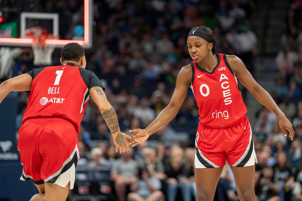 Jun 17, 2025; Minneapolis, Minnesota, USA; Las Vegas Aces forward Kierstan Bell (1) and Las Vegas Aces guard Jackie Young (0) shake hands after a made basket against the Minnesota Lynx in the first half at Target Center. Mandatory Credit: Jesse Johnson-Imagn Images