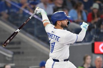 Jun 17, 2025; Toronto, Ontario, CAN;   Toronto Blue Jays shortstop Bo Bichette (11) hits a solo home run against the Arizona Diamondbacks in the ninth inning at Rogers Centre. Mandatory Credit: Dan Hamilton-Imagn Images