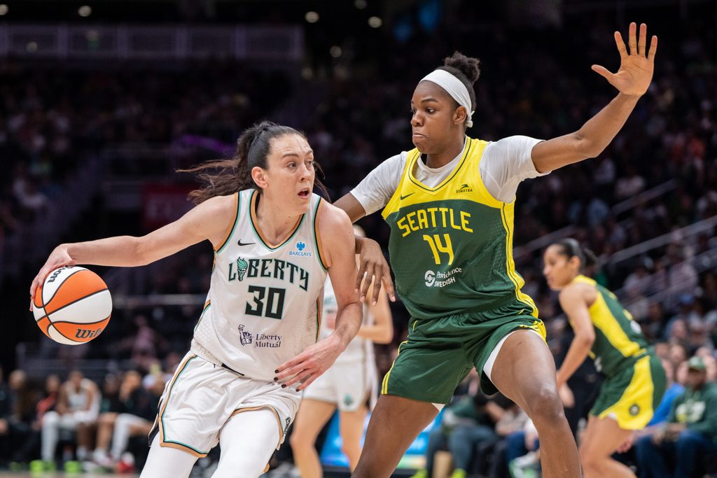 Jun 22, 2025; Seattle, Washington, USA; New York Libertyforward Breanna Stewart (30) dribbles the ball against Seattle Storm center Dominique Malonga (14) during the second half at Climate Pledge Arena. Mandatory Credit: Stephen Brashear-Imagn Images