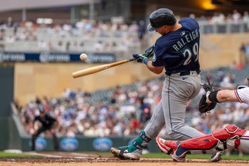 Jun 24, 2025; Minneapolis, Minnesota, USA; Seattle Mariners catcher Cal Raleigh (29) hits a RBI single against the Minnesota Twins in the third inning at Target Field. Mandatory Credit: Jesse Johnson-Imagn Images