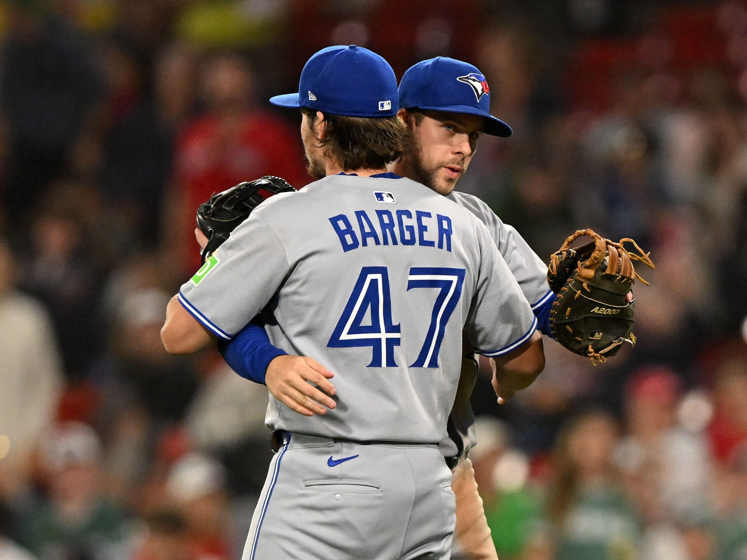 Jun 27, 2025; Boston, Massachusetts, USA; Toronto Blue Jays third baseman Addison Barger (47) celebrates with third baseman Ernie Clement (22) after a game against the Boston Red Sox at Fenway Park. Mandatory Credit: Brian Fluharty-Imagn Images
