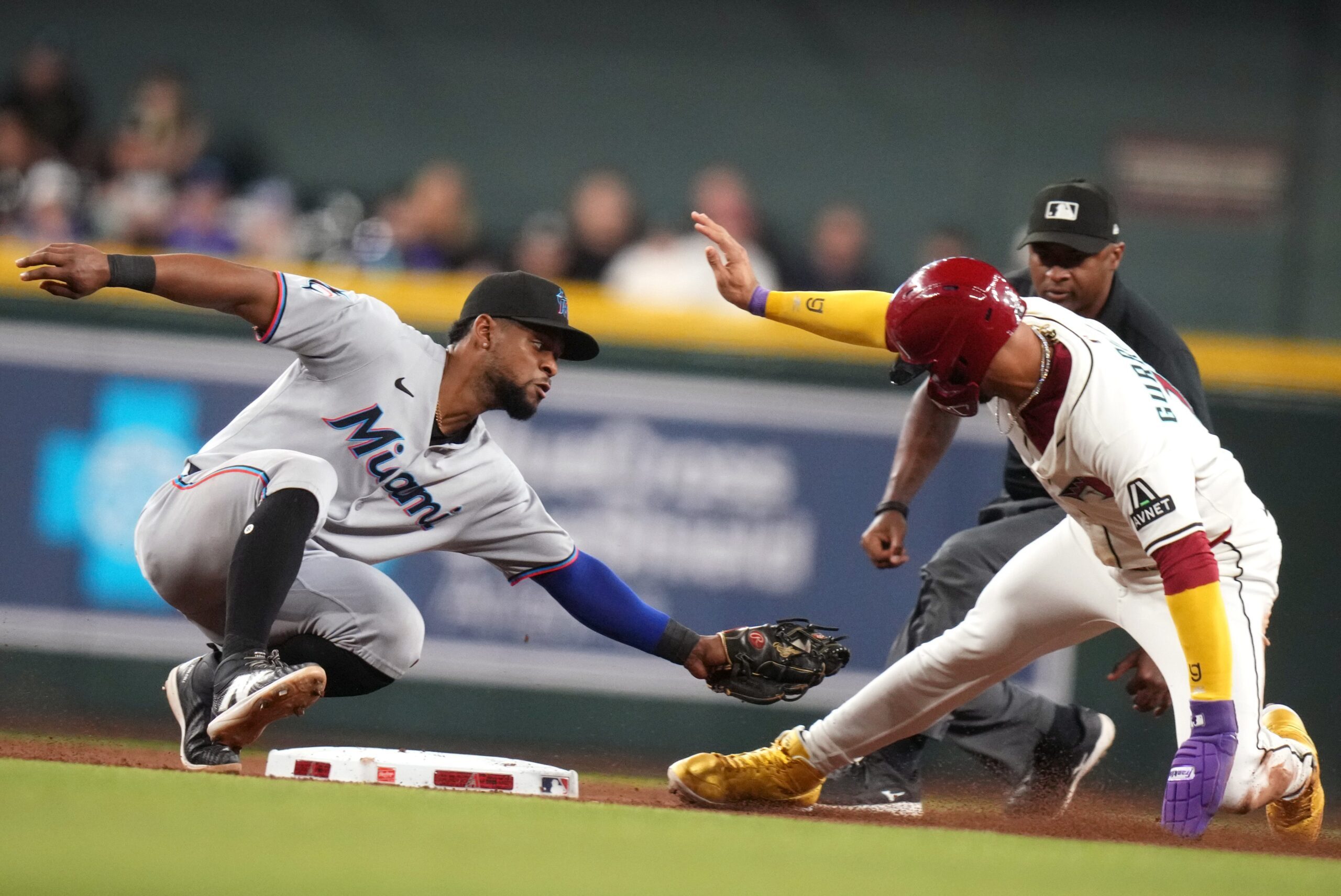 Arizona Diamondbacks base runner Lourdes Gurriel Jr. (12) is tagged out on a steal attempt at second base by Miami Marlins ifielder Otto Lopez (6) at Chase Field on Saturday, June 28, 2025.