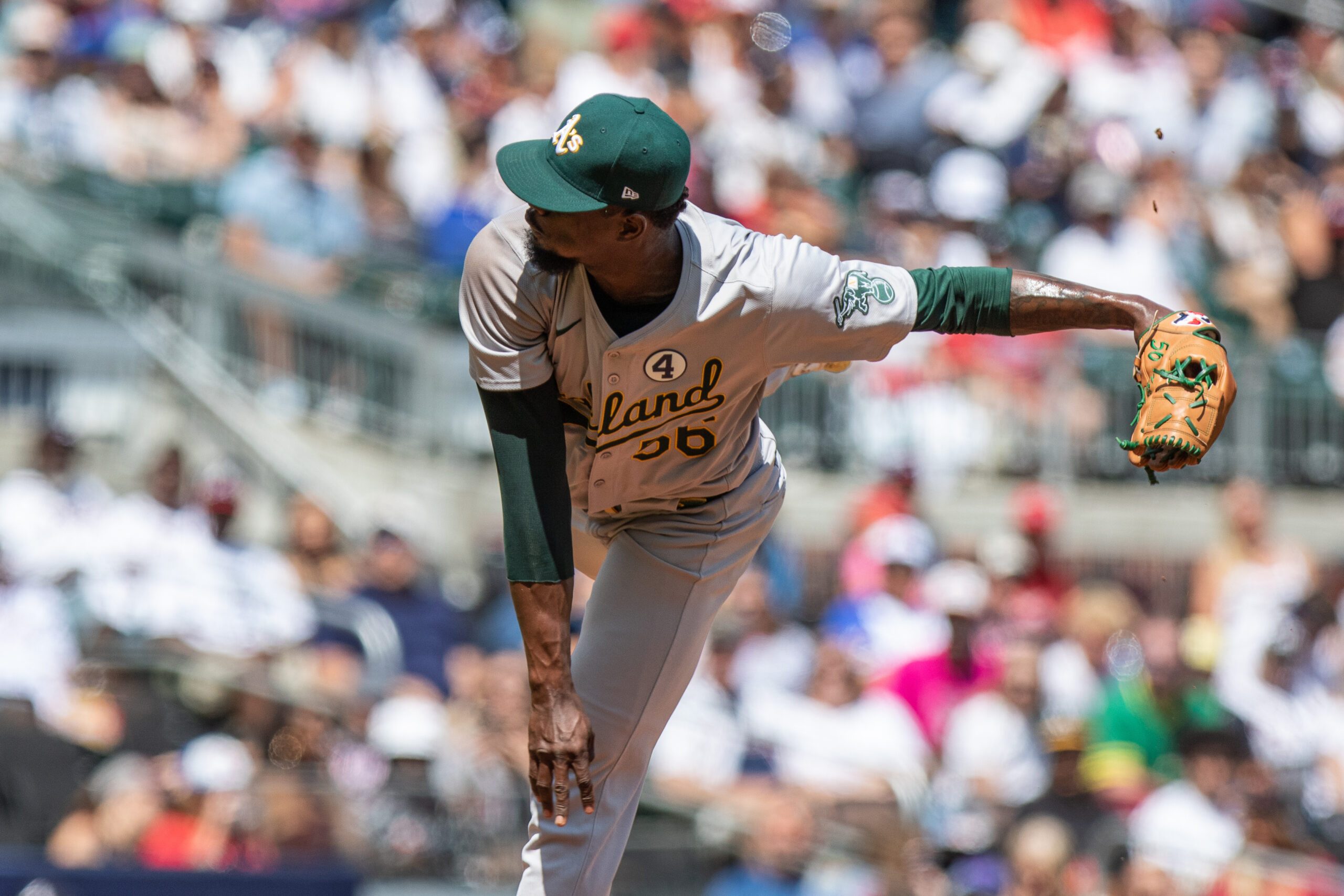 Jun 2, 2024; Cumberland, Georgia, USA;  Oakland Athletics pitcher Dany Jiménez (56) pitches the ball against the Atlanta Braves during the eighth inning at Truist Park. Mandatory Credit: Jordan Godfree-Imagn Images