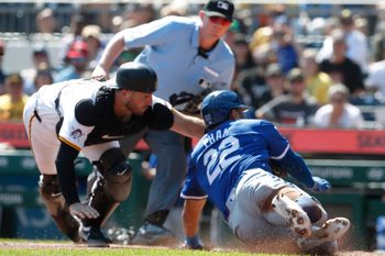 Sep 15, 2024; Pittsburgh, Pennsylvania, USA;  Pittsburgh Pirates catcher Joey Bart (14) tags Kansas City Royals outfielder Tommy Pham (22) out at home plate attempting to score a run during the third inning at PNC Park. Mandatory Credit: Charles LeClaire-Imagn Images