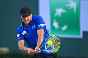 Mar 6, 2025; Indian Wells, CA, USA; Luciano Darderi (ITA) hits a ball against Hugo Gaston (FRA) in the BNP Paribas Open at the Indian Well Tennis Garden. Mandatory Credit: Jonathan Hui-Imagn Images