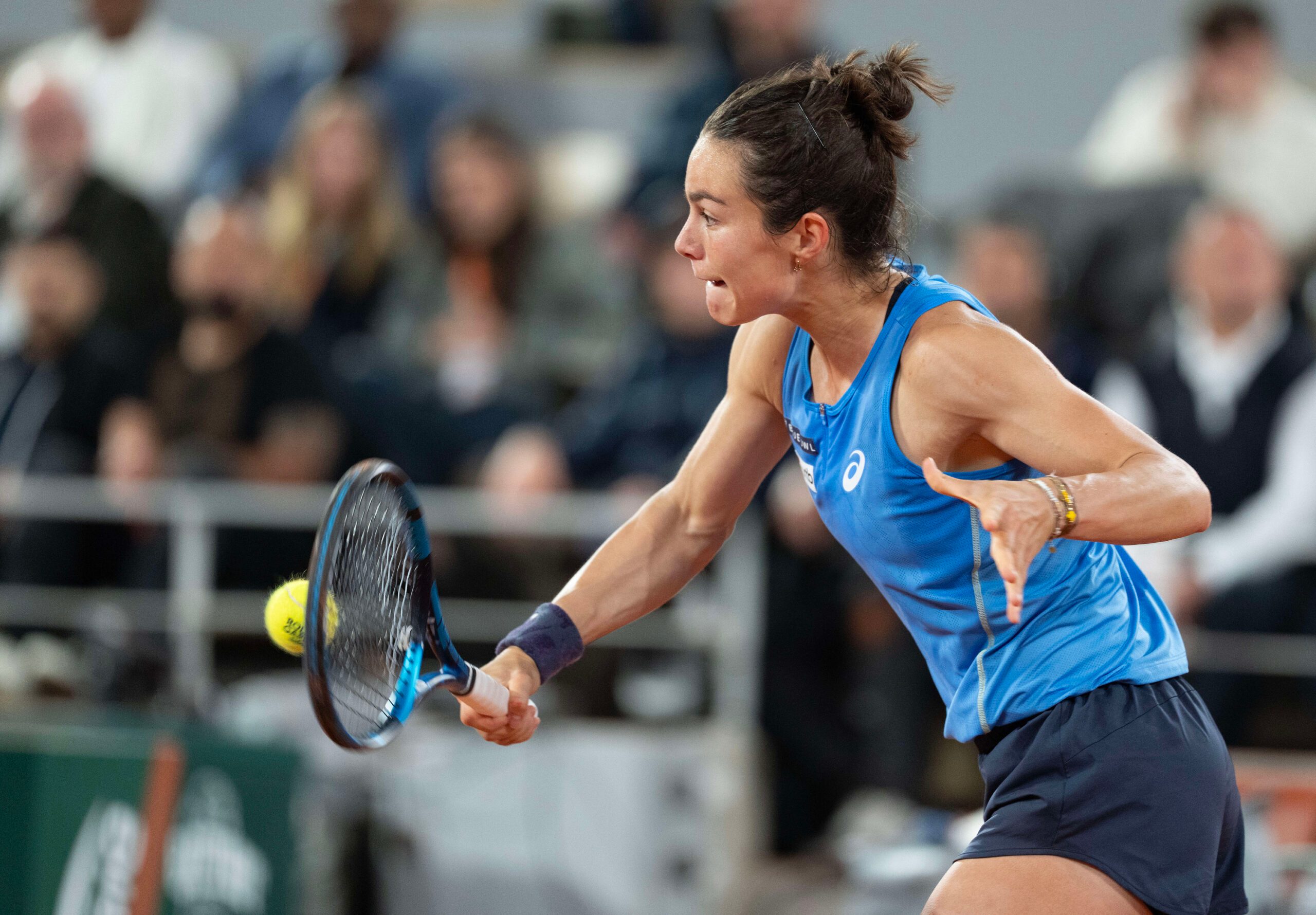 Jun 5, 2025; Paris, FR;  Lois Boisson of France returns a shot during her match against Coco Gauff of the United States on day 12 at Roland Garros Stadium. Mandatory Credit: Susan Mullane-Imagn Images