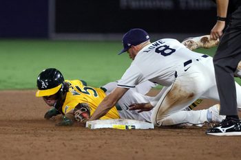 Jun 30, 2025; Tampa, Florida, USA; Tampa Bay Rays second base Brandon Lowe (8) tags out Athletics shortstop Jacob Wilson (5) during the ninth inning at George M. Steinbrenner Field. Mandatory Credit: Kim Klement Neitzel-Imagn Images