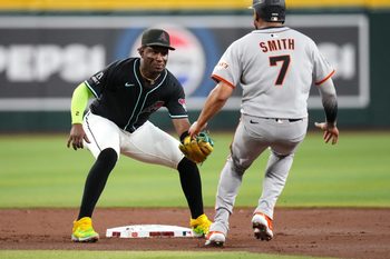 Arizona Diamondbacks infielder Geraldo Perdomo (2) tags out San Francisco Giants base runner Dominic Smith (7) at Chase Field on June 30, 2025.