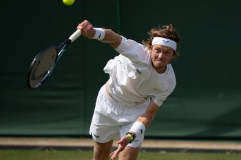 Jul 2, 2025; Wimbledon, United Kingdom; Andrey Rublev serves the ball during his match against Lloyd Harris of South Africa on day three at the All England Lawn Tennis and Croquet Club. Mandatory Credit: Susan Mullane-Imagn Images