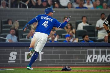 Jul 2, 2025; Toronto, Ontario, CAN; Toronto Blue Jays outfielder George Springer (4) celebrates after scoring against the New York Yankees during the eighth inning at Rogers Centre. Mandatory Credit: Kevin Sousa-Imagn Images