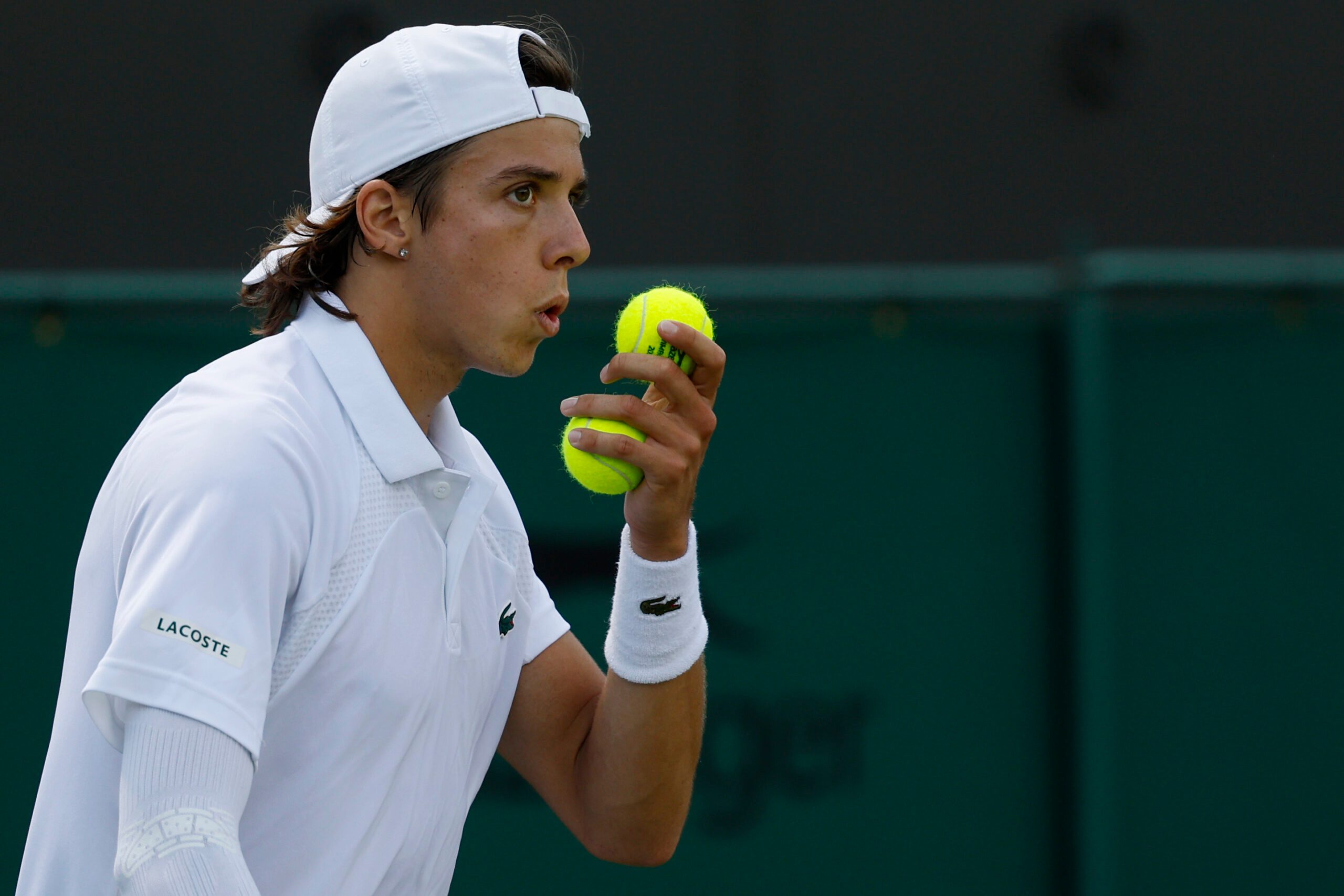 Jul 3, 2025; Wimbledon, United Kingdom; Arthur Cazaux (FRA) blows on his hand prior to serving against Alex de Minaur (AUS)(not pictured) on day four of The Championships Wimbledon 2025 at All England Lawn Tennis and Croquet Club. Mandatory Credit: Geoff Burke-Imagn Images