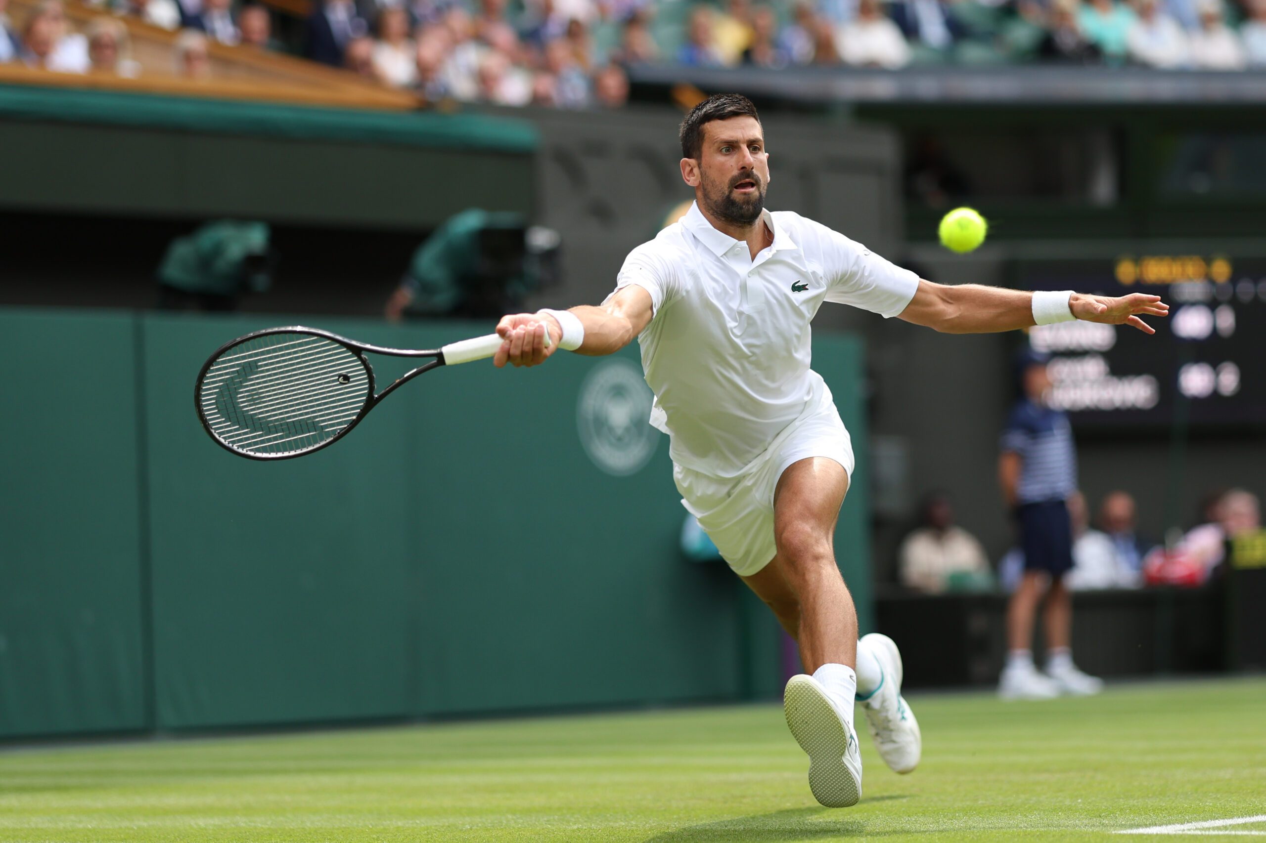 Jul 3, 2025; Wimbledon, United Kingdom; Novak Djokovic (SRB) reaches for a forehand against Daniel Evans (GBR)(not pictured) on day four of The Championships Wimbledon 2025 at All England Lawn Tennis and Croquet Club. Mandatory Credit: Geoff Burke-Imagn Images