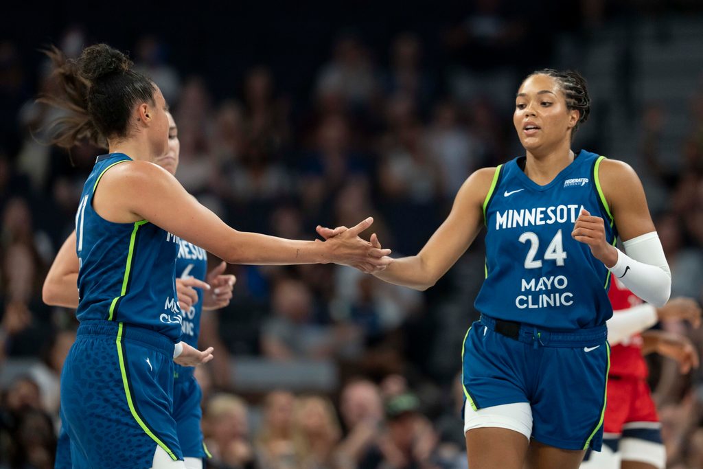 Jul 3, 2025; Minneapolis, Minnesota, USA; Minnesota Lynx forward Napheesa Collier (24) shakes hands with Minnesota Lynx guard Kayla McBride (21) after making a shot against the Washington Mystics in the first half at Target Center. Mandatory Credit: Jesse Johnson-Imagn Images