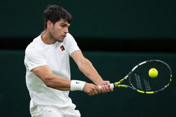 Jul 6, 2025; Wimbledon, United Kingdom; Carlos Alcaraz of Spain returns a shot during his match against Andrey Rublev on day seven at the All England Lawn Tennis and Croquet Club. Mandatory Credit: Susan Mullane-Imagn Images