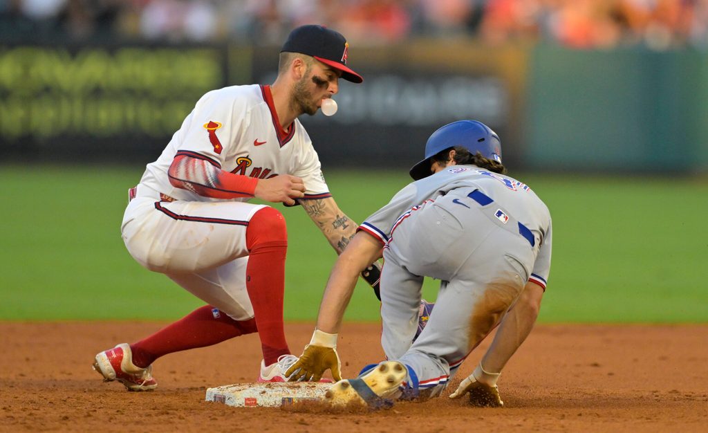 Jul 9, 2025; Anaheim, California, USA;  Texas Rangers shortstop Josh Smith (8) beats the tag by Los Angeles Angels shortstop Zach Neto (9) for a stolen base in the fourth inning at Angel Stadium. Mandatory Credit: Jayne Kamin-Oncea-Imagn Images