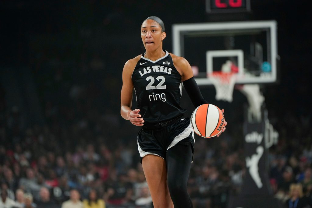 Jul 12, 2025; Las Vegas, Nevada, USA; Las Vegas Aces center A'ja Wilson (22) dribbles the ball against the Golden State Valkyries during the first half of a WNBA basketball game at Michelob Ultra Arena. Mandatory Credit: Lucas Peltier-Imagn Images
