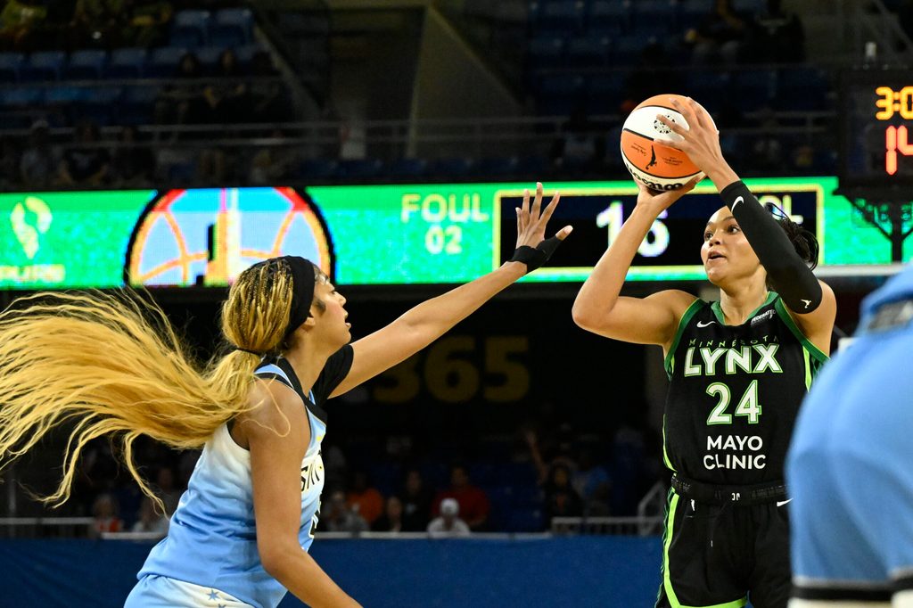 Jul 14, 2025; Chicago, Illinois, USA; Minnesota Lynx forward Napheesa Collier (24) passes the ball against Chicago Sky forward Angel Reese (5) during the first half at Wintrust Arena. Mandatory Credit: Matt Marton-Imagn Images