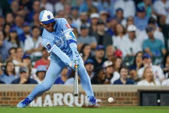 Jul 21, 2025; Chicago, Illinois, USA; Kansas City Royals shortstop Bobby Witt Jr. (7) hits an RBI-single against the Chicago Cubs during the fifth inning at Wrigley Field. Mandatory Credit: Kamil Krzaczynski-Imagn Images
