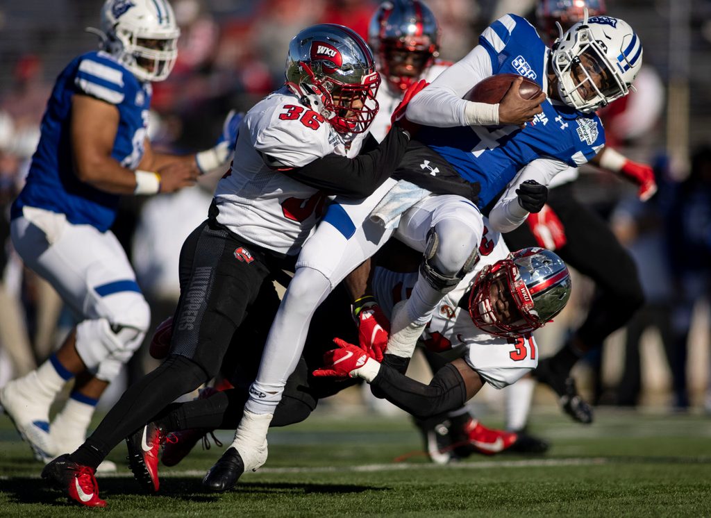 Dec 26, 2020; Mobile, AL, USA; Western Kentucky Hilltoppers linebacker Kyle Bailey (36) and defensive back Antwon Kincade (31) hit Georgia State Panthers quarterback Cornelious Brown IV (4) during the first quarter at Ladd-Peebles Stadium. Mandatory Credit: Vasha Hunt-Imagn Images