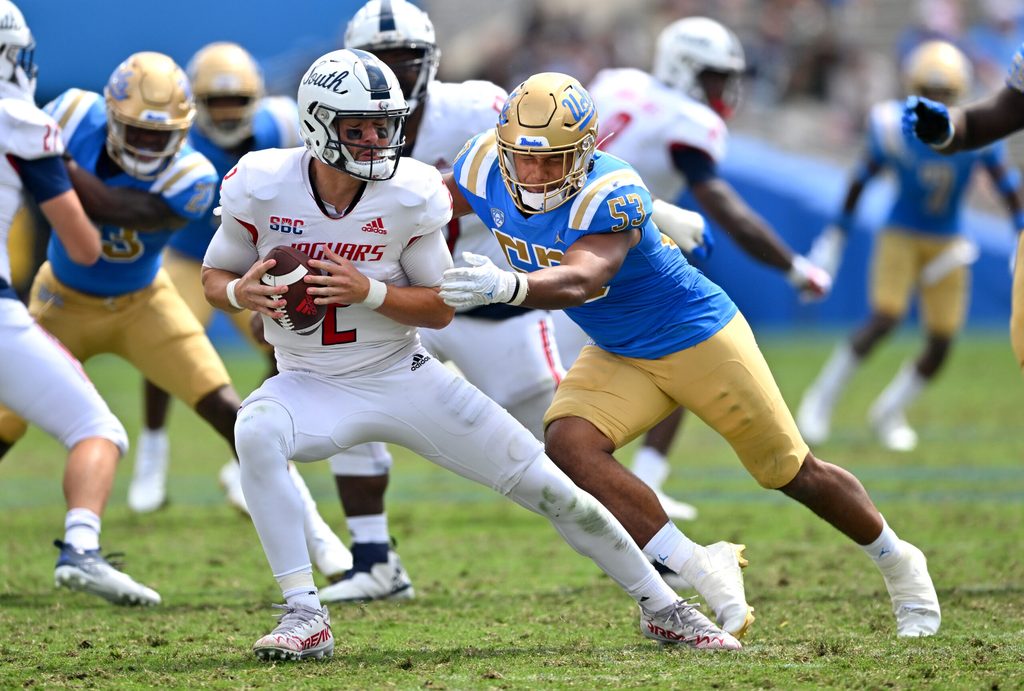 Sep 17, 2022; Pasadena, California, USA; South Alabama Jaguars quarterback Carter Bradley (2) escapes a sack by UCLA Bruins linebacker Darius Muasau (53) in the second half against the UCLA Bruins at the Rose Bowl. Mandatory Credit: Jayne Kamin-Oncea-Imagn Images