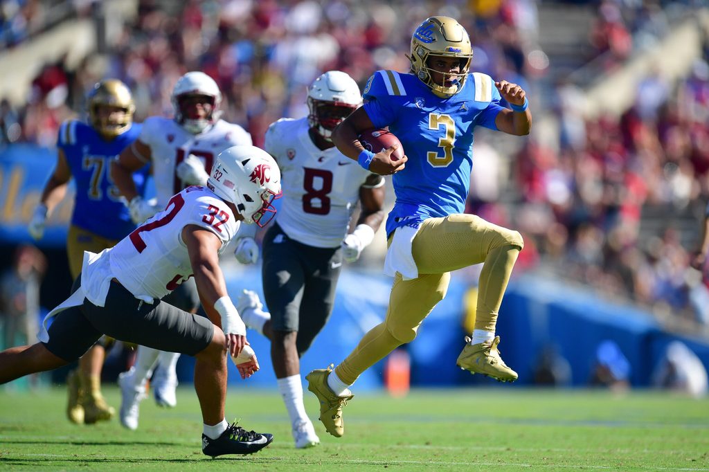 Oct 7, 2023; Pasadena, California, USA; UCLA Bruins quarterback Dante Moore (3) runs the ball ahead of Washington State Cougars defensive back Tanner Moku (32) during the second half at Rose Bowl. Mandatory Credit: Gary A. Vasquez-Imagn Images