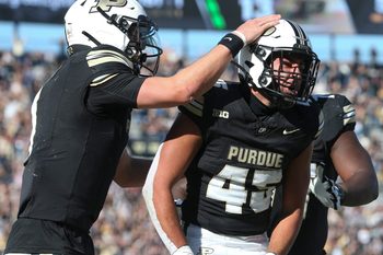 Purdue Boilermakers running back Devin Mockobee (45) celebrates with Purdue Boilermakers quarterback Hudson Card (1) and Purdue Boilermakers offensive lineman Jalen Grant (75) after scoring Saturday, Nov. 2, 2024, during the NCAA football game against the Northwestern Wildcats at Ross-Ade Stadium in West Lafayette, Ind. Northwestern Wildcats won 26-20.