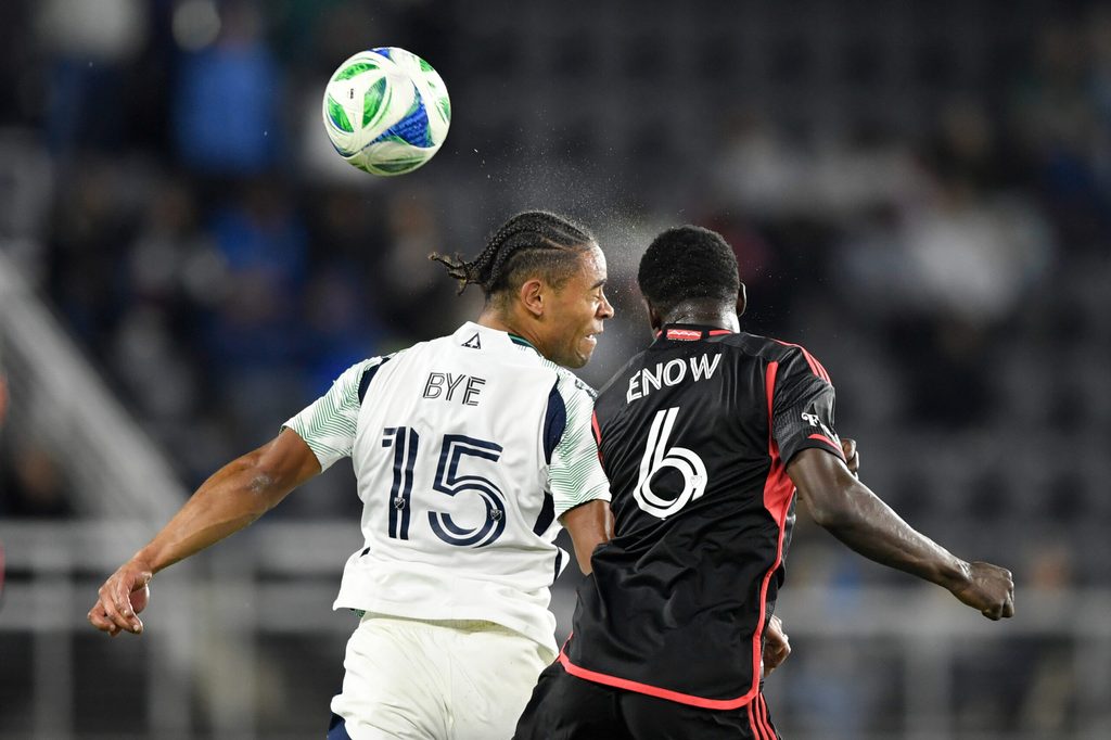 May 28, 2025; Washington, District of Columbia, USA; New England Revolution midfielder Brandon Bye (15) and D.C. United midfielder Boris Enow (6) go after the ball during the second half of the game at Audi Field. Mandatory Credit: Hannah Foslien-Imagn Images
