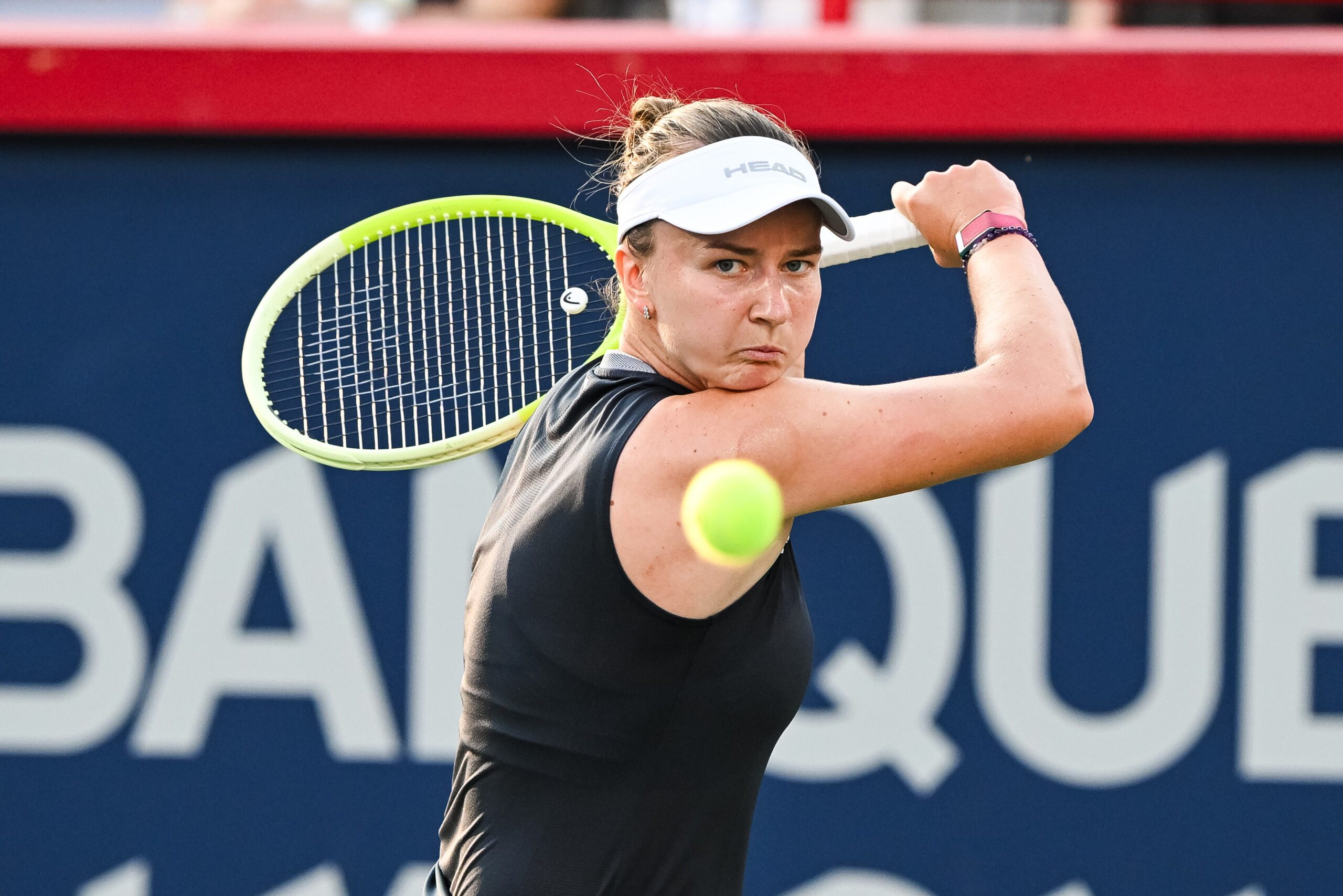 Jul 27, 2025; Montreal, QC, Canada; Barbora Krejcikova (CZE) returns the ball against Bianca Andreescu (CAN) in first round play at IGA Stadium. Mandatory Credit: David Kirouac-Imagn Images
