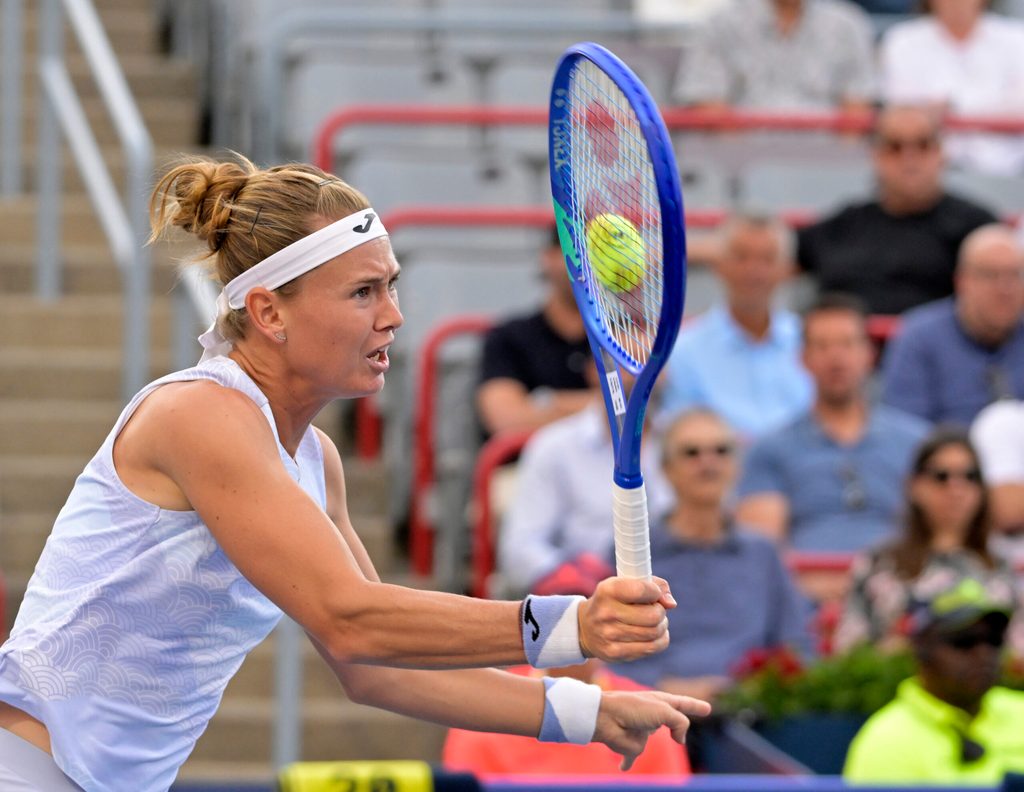 Jul 31, 2025; Montreal, QC, Canada; Marie Bouzkova (CZE) volleys against Victoria Mboko (CAN) in third round play at IGA Stadium. Mandatory Credit: Eric Bolte-Imagn Images