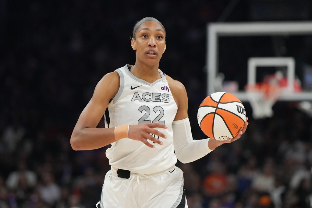 Aug 15, 2025; Phoenix, Arizona, USA; Las Vegas Aces center A'ja Wilson (22) brings the ball up court against the Phoenix Mercury in the first half at Footprint Center. Mandatory Credit: Rick Scuteri-Imagn Images
