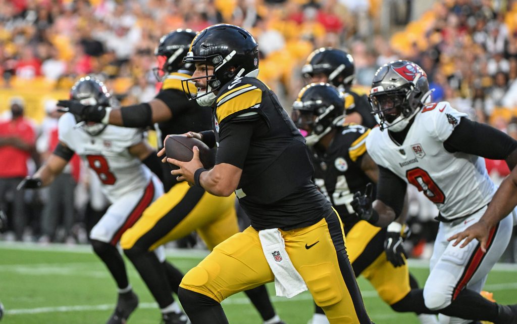 Aug 16, 2025; Pittsburgh, Pennsylvania, USA; Pittsburgh Steelers quarterback Mason Rudolph (2) scrambles away from Tampa Bay Buccaneers linebacker Yaya Diaby (0) during the first quarter at Acrisure Stadium. Mandatory Credit: Barry Reeger-Imagn Images
