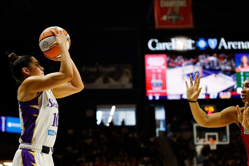 Aug 17, 2025; Washington, District of Columbia, USA; Los Angeles Sparks guard Kelsey Plum (10) shoots the ball as Washington Mystics forward Kiki Iriafen (44) defends in the first half at CareFirst Arena. Mandatory Credit: Geoff Burke-Imagn Images