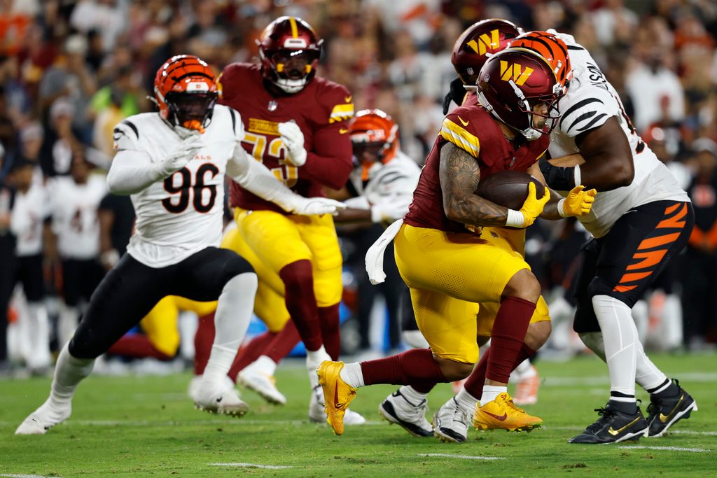 Aug 18, 2025; Landover, Maryland, USA; Washington Commanders running back Chris Rodriguez Jr. (36) carries the ball against the Cincinnati Bengals during the second quarter at Northwest Stadium. Mandatory Credit: Geoff Burke-Imagn Images