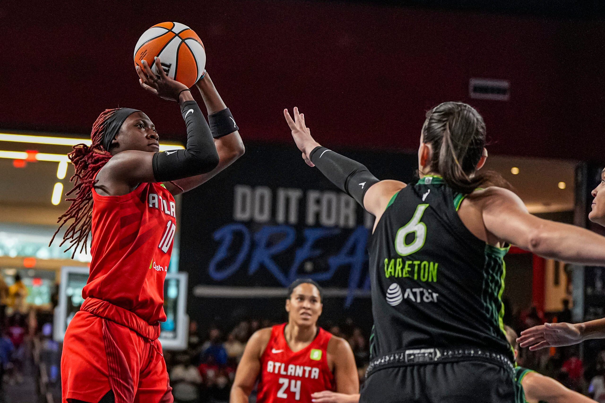Aug 21, 2025; College Park, Georgia, USA; Atlanta Dream guard Rhyne Howard (10) shoots over Minnesota Lynx forward Bridget Carleton (6) during the first half at Gateway Center Arena at College Park. Mandatory Credit: Dale Zanine-Imagn Images