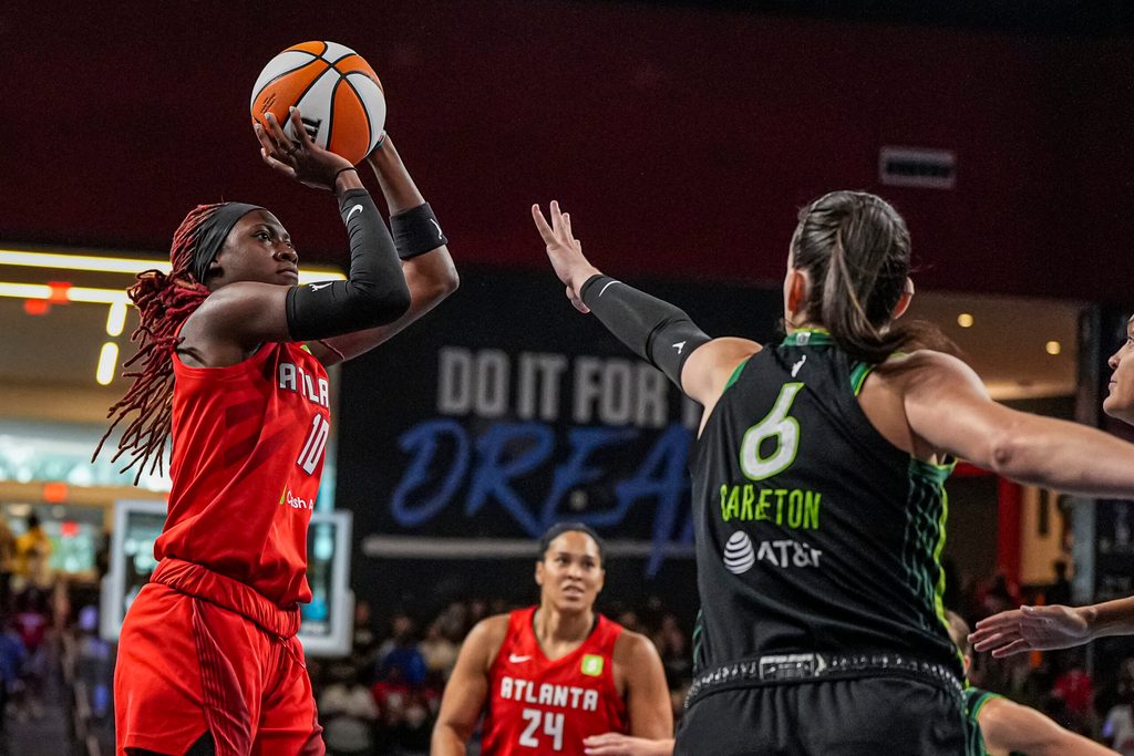 Aug 21, 2025; College Park, Georgia, USA; Atlanta Dream guard Rhyne Howard (10) shoots over Minnesota Lynx forward Bridget Carleton (6) during the first half at Gateway Center Arena at College Park. Mandatory Credit: Dale Zanine-Imagn Images