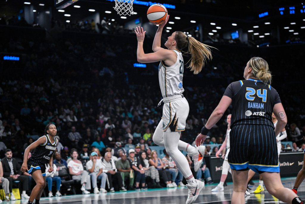 Aug 21, 2025; Brooklyn, New York, USA; New York Liberty guard Sabrina Ionescu (20) drives past Chicago Sky guard Rachel Banham (24) during the second half at Barclays Center. Mandatory Credit: John Jones-Imagn Images