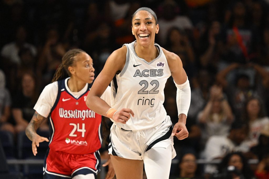 Aug 23, 2025; Washington, District of Columbia, USA; Las Vegas Aces center A'ja Wilson (22) is all smiles after a basket against the Washington Mystics during the fourth quarter at CareFirst Arena. Mandatory Credit: Rafael Suanes-Imagn Images