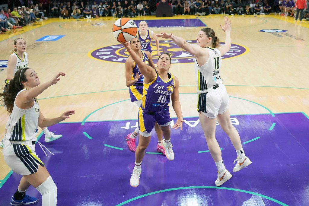 Aug 20, 2025; Los Angeles, California, USA; LA Sparks guard Kelsey Plum (10) shoots the ball against Dallas Wings center Luisa Geiselsoder (18) in the second half at Crypto.com Arena. Mandatory Credit: Kirby Lee-Imagn Images