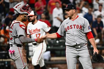 Aug 26, 2025; Baltimore, Maryland, USA; Boston Red Sox pitcher Justin Wilson (right) and catcher Carlos Narvaez (left) celebrate the win against the Baltimore Orioles at Oriole Park at Camden Yards. Mandatory Credit: James A. Pittman-Imagn Images