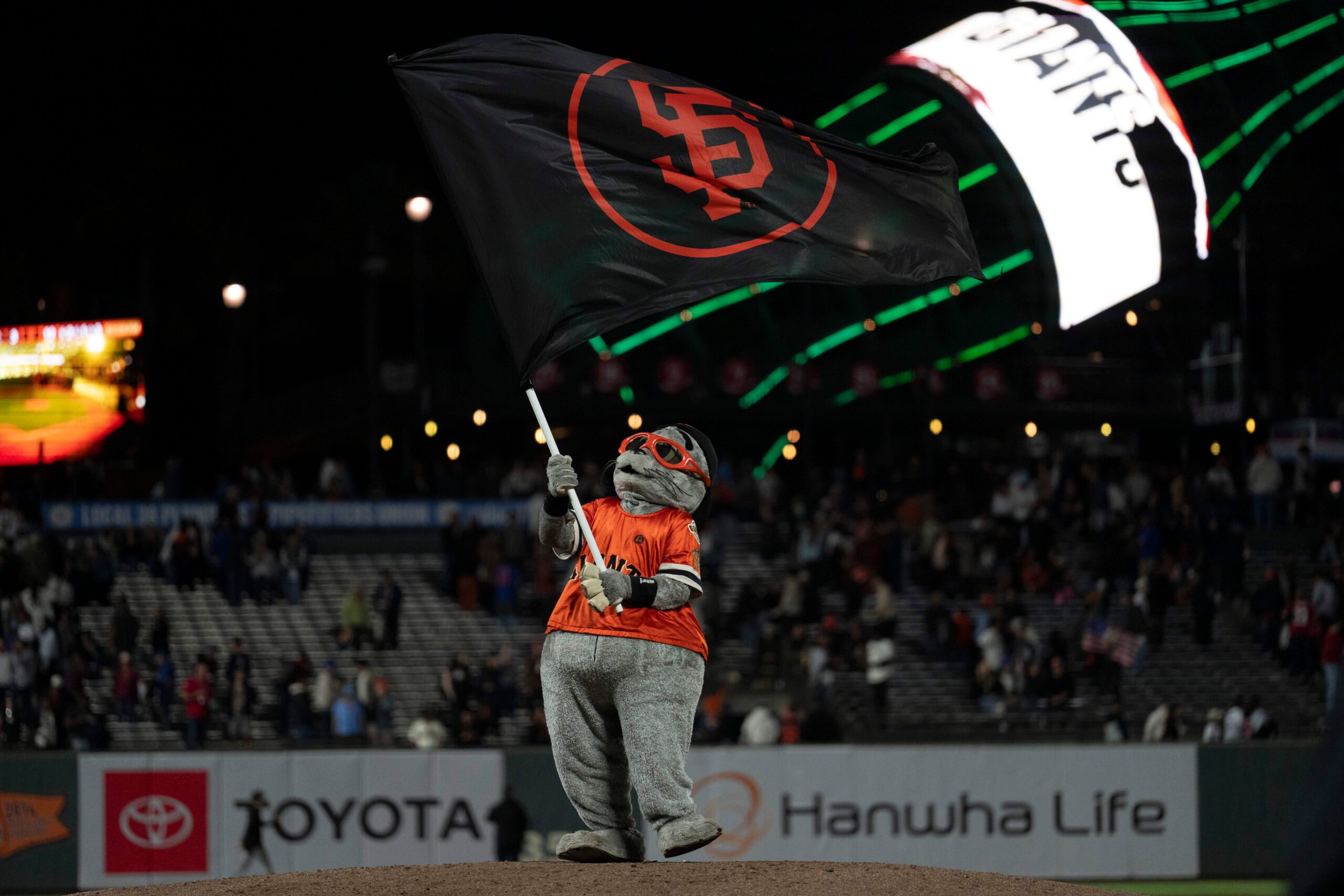 Aug 27, 2025; San Francisco, California, USA;  San Francisco Giants mascot Lou Seal celebrates after defeating the Chicago Cubs at Oracle Park. Mandatory Credit: Stan Szeto-Imagn Images
