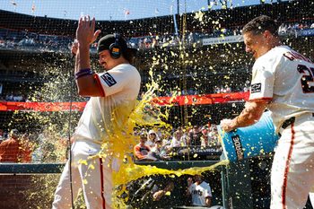 Aug 28, 2025; San Francisco, California, USA; San Francisco Giants shortstop Willy Adames (2) gets a gatorade splash by third baseman Matt Chapman (26) after the game against the Chicago Cubs  at Oracle Park. Mandatory Credit: Sergio Estrada-Imagn Images