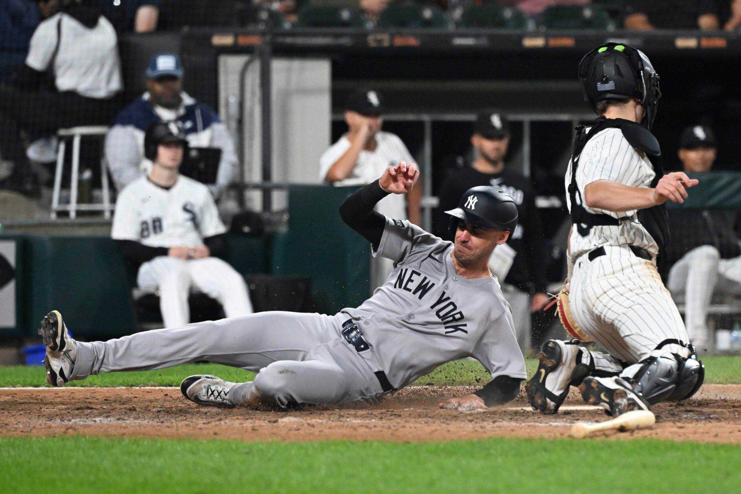 Aug 28, 2025; Chicago, Illinois, USA;  New York Yankees outfielder Cody Bellinger (35) slides safely past Chicago White Sox catcher Kyle Teel (8) during the ninth inning at Rate Field. Mandatory Credit: Matt Marton-Imagn Images