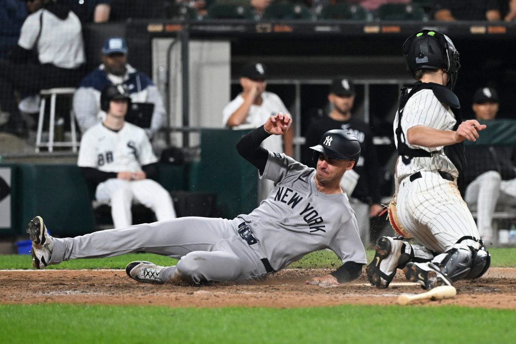 Aug 28, 2025; Chicago, Illinois, USA; New York Yankees outfielder Cody Bellinger (35) slides safely past Chicago White Sox catcher Kyle Teel (8) during the ninth inning at Rate Field. Mandatory Credit: Matt Marton-Imagn Images
