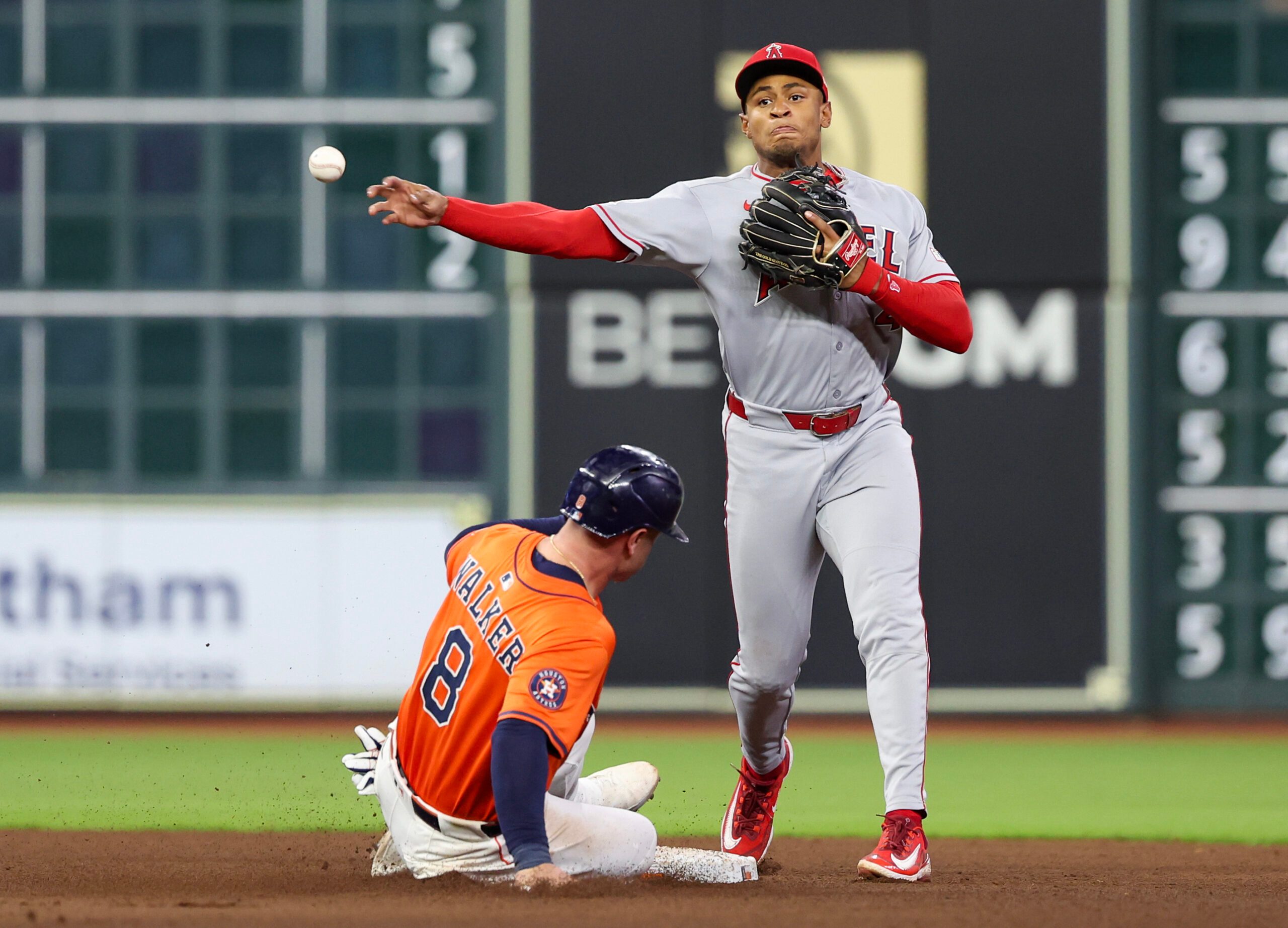 Aug 29, 2025; Houston, Texas, USA; Los Angeles Angels second baseman Christian Moore (4) forces Houston Astros first baseman Christian Walker (8) out at second base but can’t turn the double play in time in the sixth inning at Daikin Park. Mandatory Credit: Thomas Shea-Imagn Images