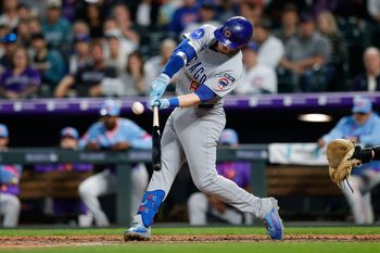 Aug 29, 2025; Denver, Colorado, USA; Chicago Cubs left fielder Ian Happ (8) hits an RBI ground rule double in the fifth inning against the Colorado Rockies at Coors Field. Mandatory Credit: Isaiah J. Downing-Imagn Images