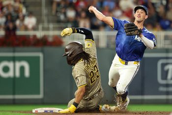 Aug 29, 2025; Minneapolis, Minnesota, USA; Minnesota Twins shortstop Brooks Lee (2) forces out San Diego Padres right fielder Fernando Tatis Jr. (23) at second base on a double play during the fifth inning at Target Field. Mandatory Credit: Matt Krohn-Imagn Images